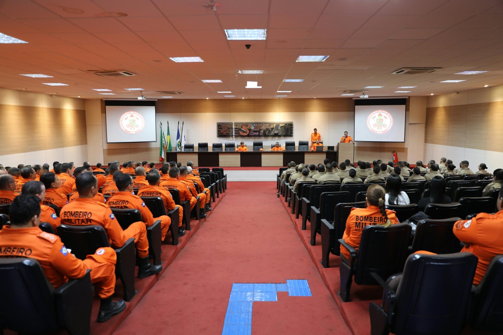 A safety meeting being conducted on a bustling film set before action begins