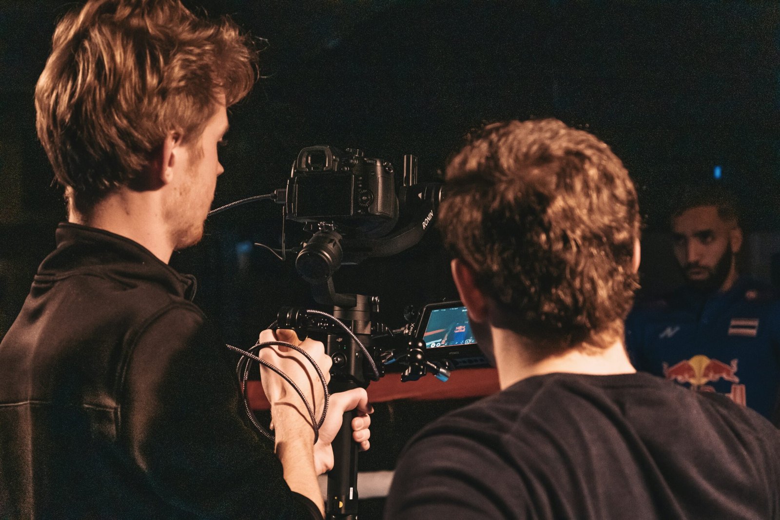 A stunt coordinator instructing a performer on set.