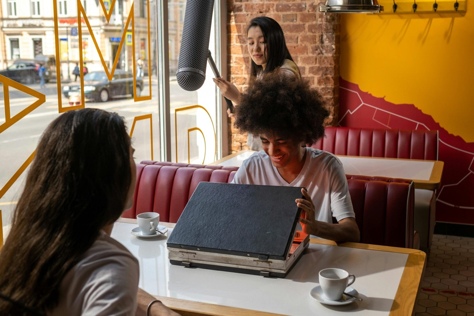 Film crew setting up equipment under supervision near a city landmark.