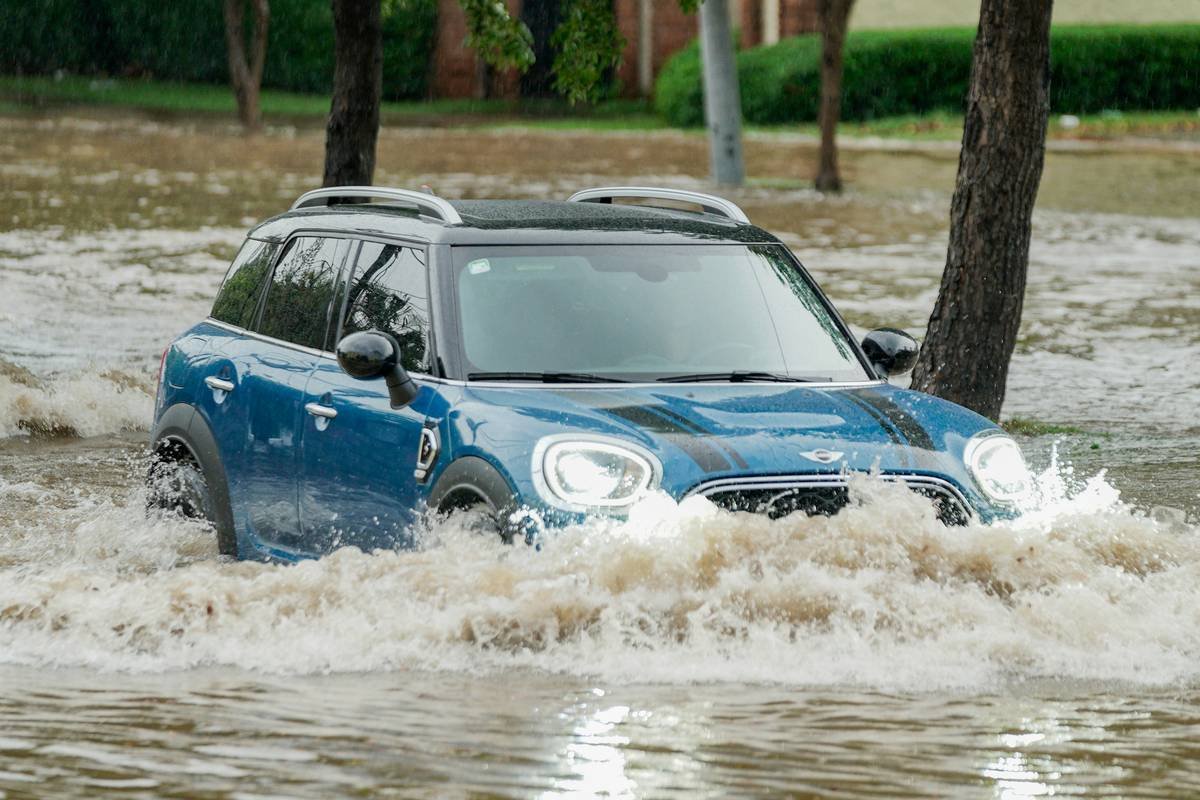 A film crew packing up equipment due to sudden rain.